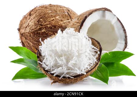 Coconut fruit and shredded coconut flakes in the piece of shell isolated on white background. Stock Photo