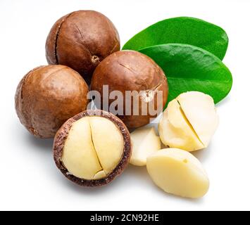 Macadamia nuts with peeled macadamia and leaves isolated on a white background. Stock Photo