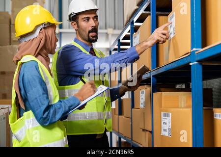 Warehouse manager talk with worker about logistic Stock Photo