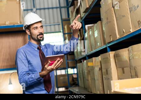 Middle east warehouse manager using tablet do inventory Stock Photo