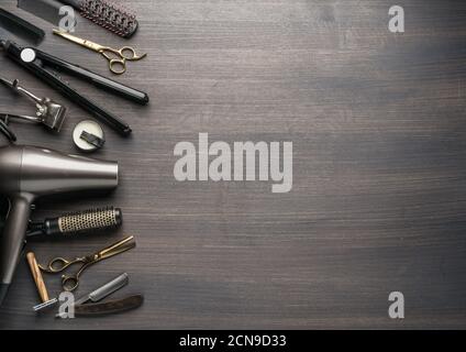 Classic grooming and hairdressing tools on wooden background. Top view on barbershop instruments  laying on dark wooden table. Stock Photo