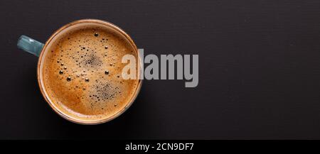 Cup of coffee on black background. Copy space. Top view. Flat lay. Stock Photo