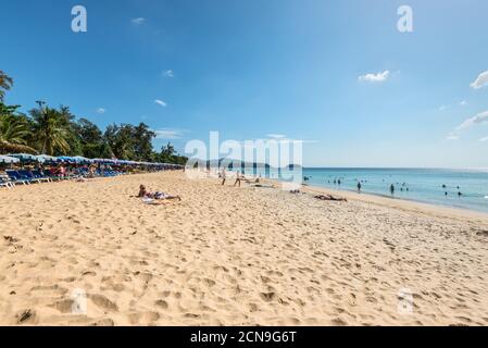Phuket, Thailand - November 29, 2019: People relax on the Karon beach. This is one of the most popular beaches among tourists in Phuket island, Thaila Stock Photo