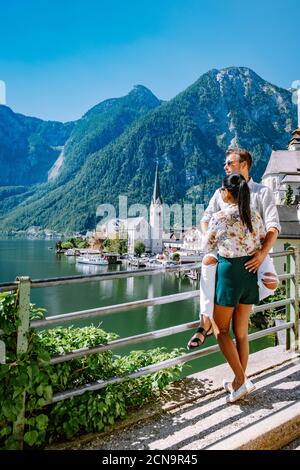 couple visit Hallstatt village on Hallstatter lake in Austrian Alps Austria Stock Photo