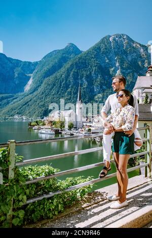 couple visit Hallstatt village on Hallstatter lake in Austrian Alps Austria Stock Photo