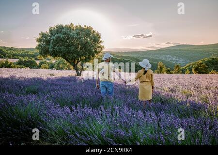 Ardeche lavender fields in the south of France during sunset, Lavender fields in Ardeche in southeast France, couple men and wom Stock Photo