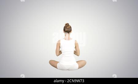 Beautiful young woman wearing sportswear practicing yoga sitting Stock Photo