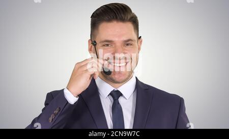 Handsome businessman with headset looking into camera and smilin Stock Photo