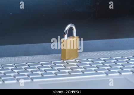 padlock placed on a laptop keyboard, safeguarding your computer concept Stock Photo