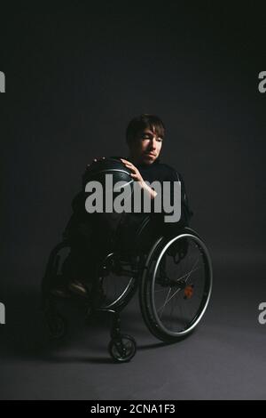 Male paraplegic athlete with basketball in wheelchair Stock Photo