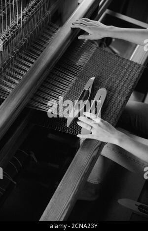 Woman working at loom in workshop Stock Photo