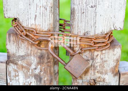 Rusty iron lock on the old gate Stock Photo