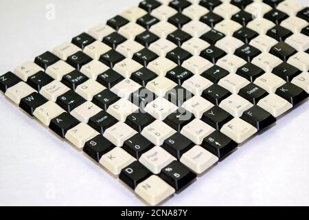 a set of keys from old computer keyboards laid out on the table in a staggered manner Stock Photo