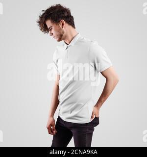 White textile t-shirt template on guy standing sideways and hand in black jeans pocket, blank polo for design presentation, logo. Mockup of stylish me Stock Photo