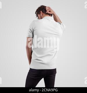 Blank white t-shirt template on guy in black jeans holding his head, polo for online store advertising and design presentation. Stylish clothing mocku Stock Photo