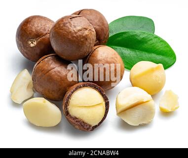 Macadamia nuts with peeled macadamia and leaves isolated on a white background. Stock Photo
