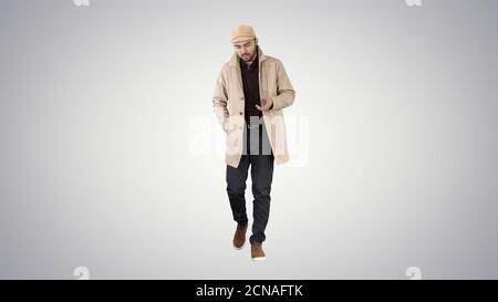 Thoughtful look Man walking and talking to himself on gradient b Stock Photo