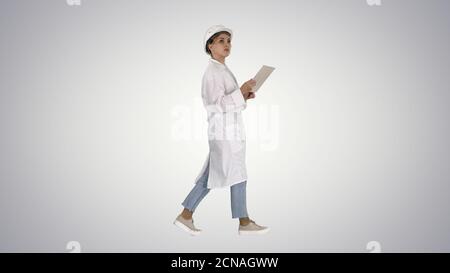 Young technician inspecting and taking necessary notes on digita Stock Photo