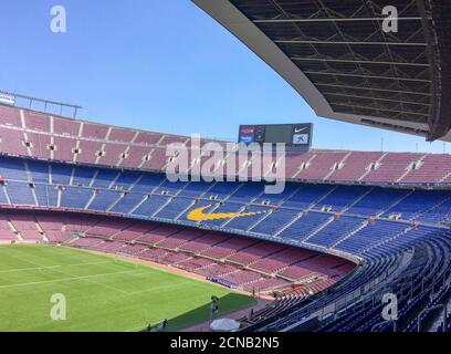 Spain, Catalonia, Barcelona 17/06/2017 empty stands of the stadium, empty stadium bleachers, soccer field on a sunny day, clear sky and a green lawn Stock Photo