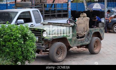 Cambodia, Siem Reap 12/08/2018 old collapsing car, army jeep in the parking lot Stock Photo