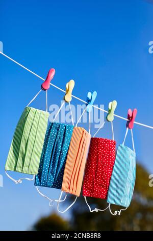 colourful face masks hanging on a washing line Stock Photo