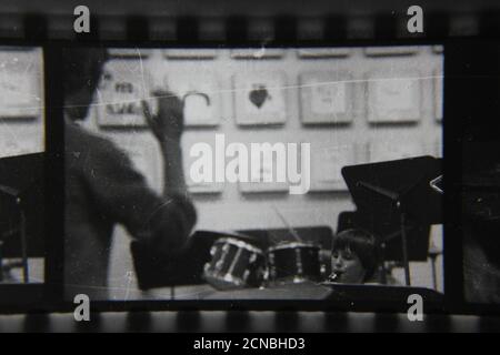 Fine 1970s vintage black and white photography of a man conducting a school band. Stock Photo