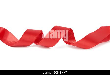 twisted red textile tape for belts and handles of bags isolated on a white background Stock Photo
