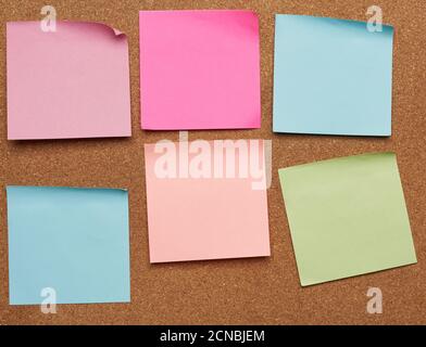 colorful paper stickers glued on brown balsa board, idea and multitasking Stock Photo