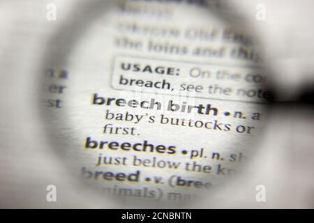 The word or phrase Breech birth in a dictionary Stock Photo