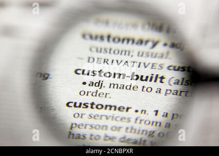 The word or phrase Custom-built in a dictionary Stock Photo