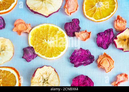 Healthy food organic nutrition. Sliced and dried apple, orange, carrot and beetroot in a row on textile background. Stock Photo