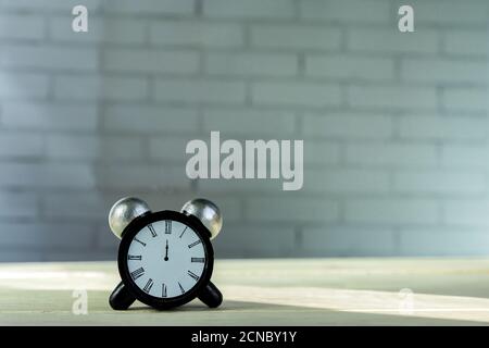 Alarm clock decoration figure on wooden table. Copy space for text Stock Photo