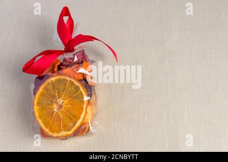 Healthy food organic nutrition. Sliced and dried apple, orange, carrot and beetroot in gift package on textile background. Stock Photo