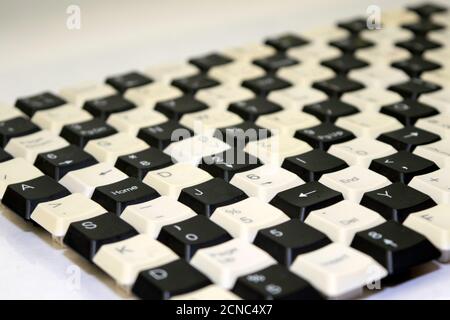 a set of keys from old computer keyboards laid out on the table in a staggered manner Stock Photo