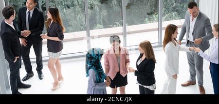 Many business people gathering in modern office building for business conference in the city. Businessmen and businesswomen communication and human Stock Photo