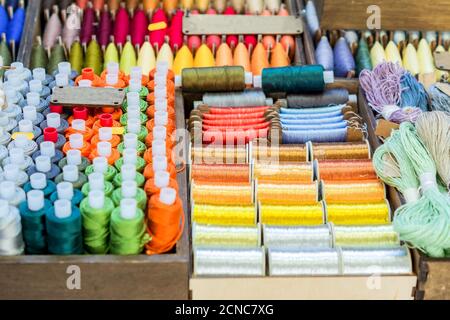 Assortment of multicolored thread spools for sewing Stock Photo