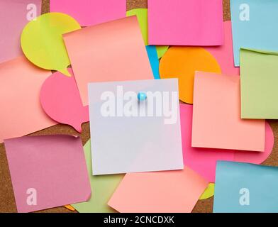 colorful paper stickers glued on brown balsa board, idea and multitasking Stock Photo