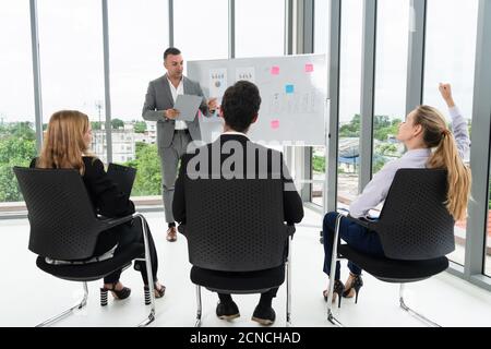 Businesswomen and businessmen attending group meeting conference in office room. Corporate business team concept. Stock Photo