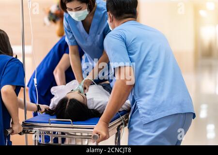 Medical team do CPR to injured patient on gurney Stock Photo