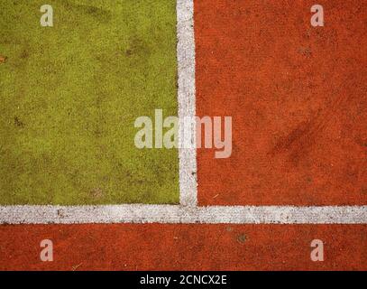 Hairy carpet on outside hanball playground. Floor of sports court with white marking lines. Stock Photo