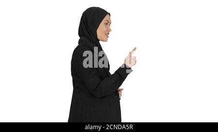 Smiling Arab woman wearing hijab talking about business while wa Stock Photo