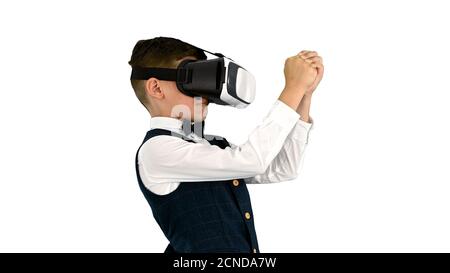 Excited boy in formal wear playing the sword game in virtual rea Stock Photo