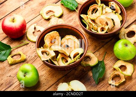 Apple chips on rustic wooden background.Dried apples Stock Photo