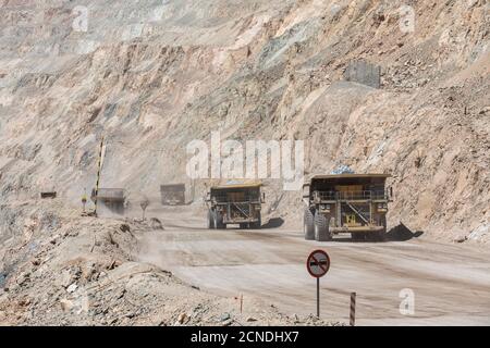 Huge dump trucks working the Chuquicamata open pit copper mine, the largest by volume in the world, Chile Stock Photo