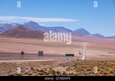Highway going through stratovolcanoes in the Andean Central Volcanic Zone, Antofagasta Region, Chile Stock Photo