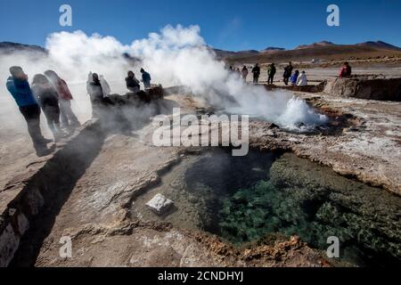 Tourists at the Geysers del Tatio (El Tatio), the third largest geyser field in the world, Andean Central Volcanic Zone, Antofagasta Region, Chile Stock Photo