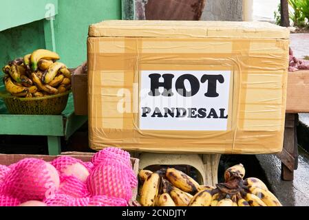 Close-up of a styrofoam box in a bakery market store to keep pandesal bread fresh and hot. Pan de sal is a affordable filipino delicacy wheat bread. Stock Photo