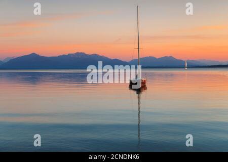 Sailing boat at sunset, Lake Chiemsee and Chiemgau Alps, Upper Bavaria, Germany, Europe Stock Photo