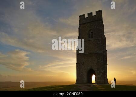 St. Michael's Tower silhouetted at sunset, on the summit of Glastonbury Tor, Glastonbury, Somerset, England, United Kingdom, Europe Stock Photo