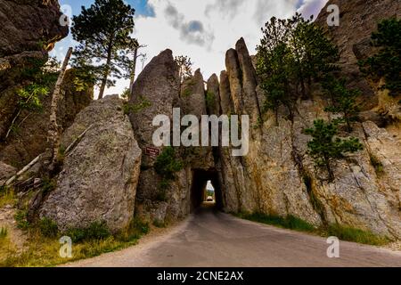 Tiny road passing under a small mountain in the Black Hills of Keystone, South Dakota, United States of America Stock Photo